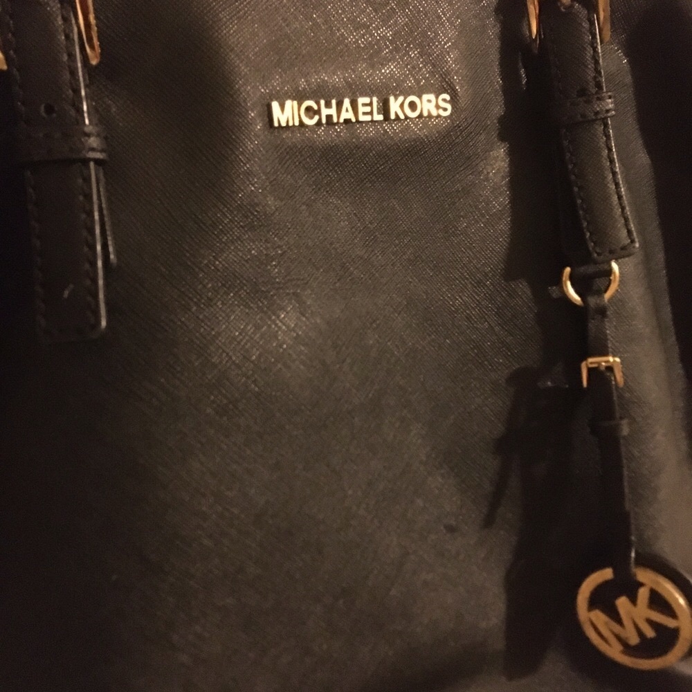 This Michael K bag is still in good use,wear on strips but no stains.
